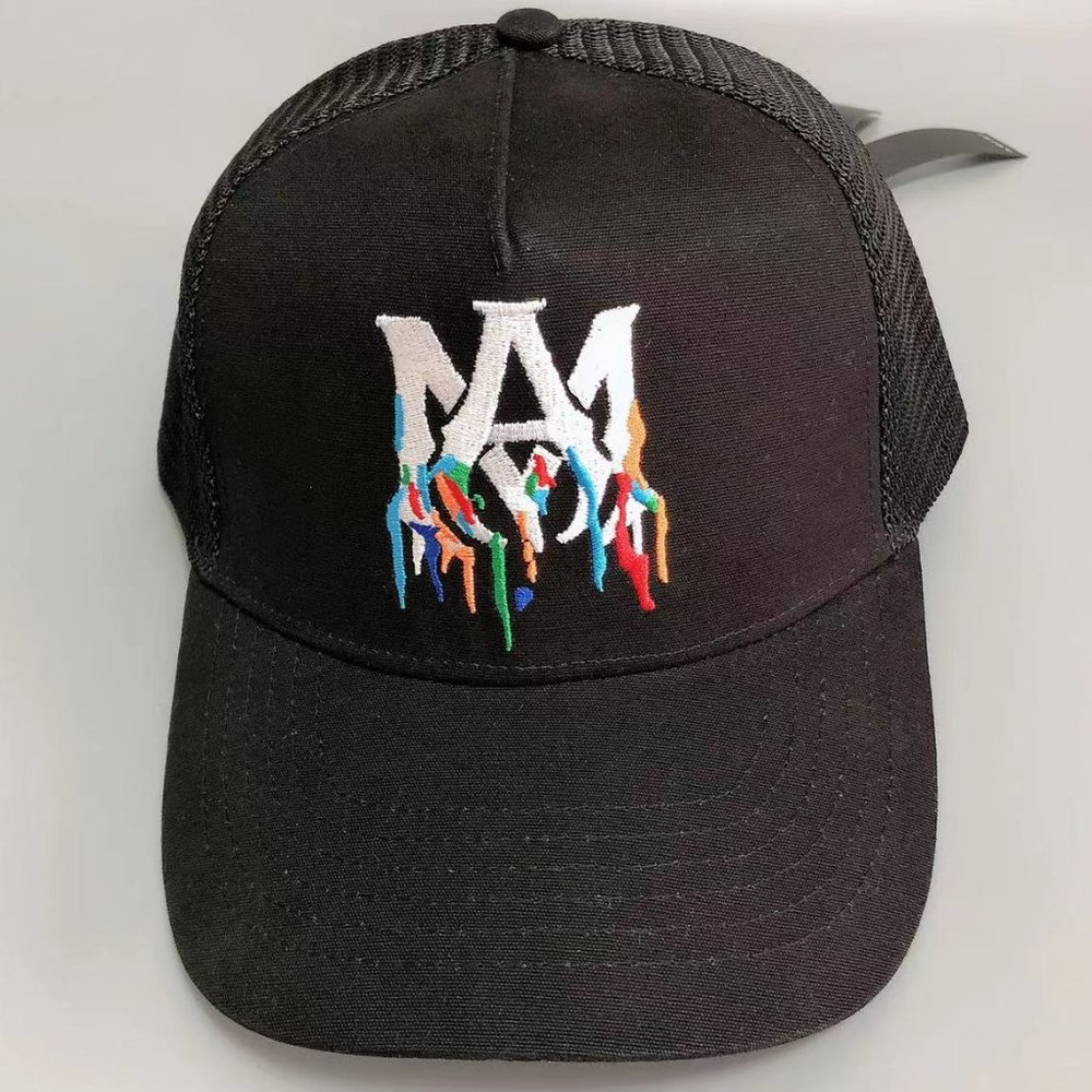 The AMIRI logo is embroidered on a black trucker hat